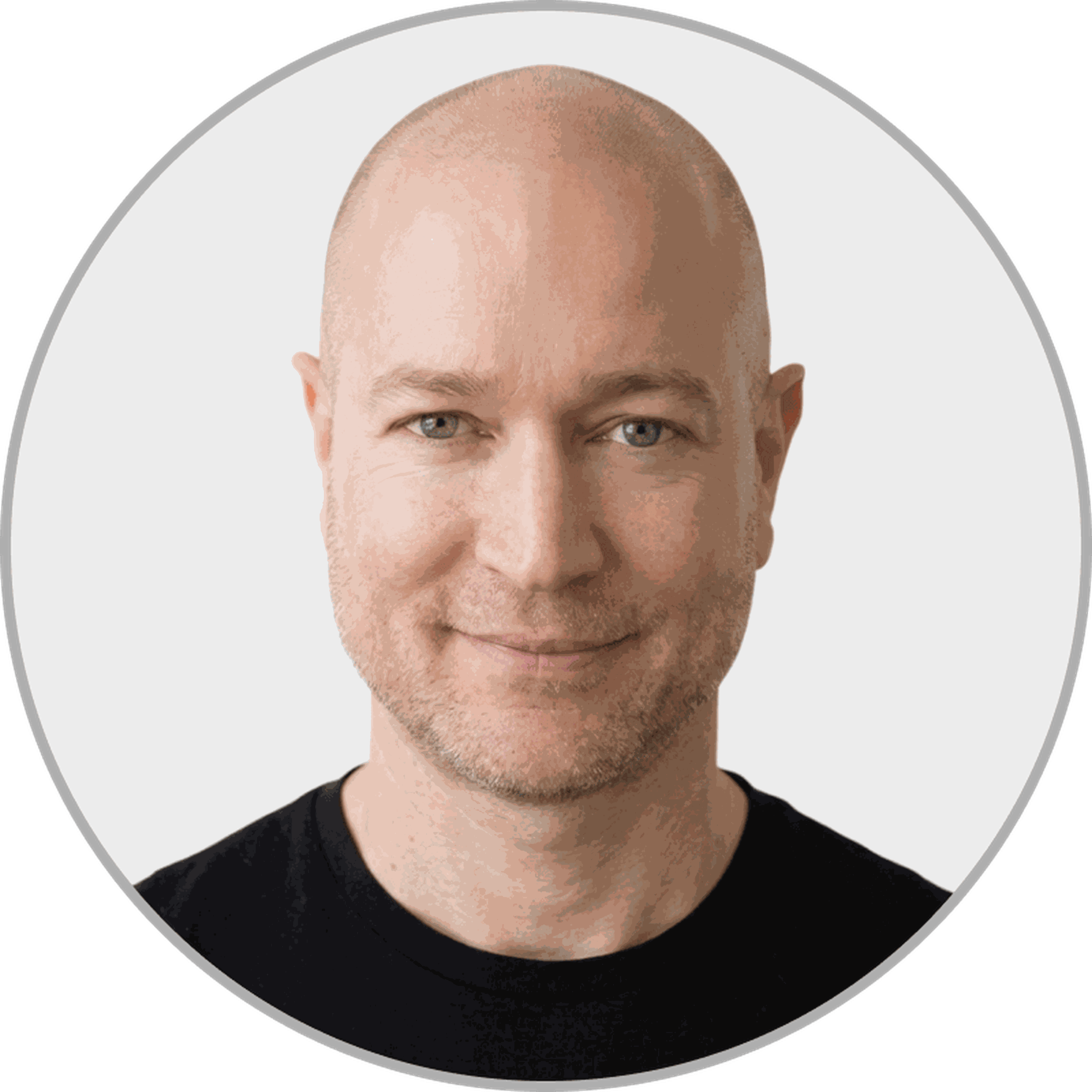 A headshot of David Moradi. A caucasian male with no hair wearing a dark gray t-shirt.