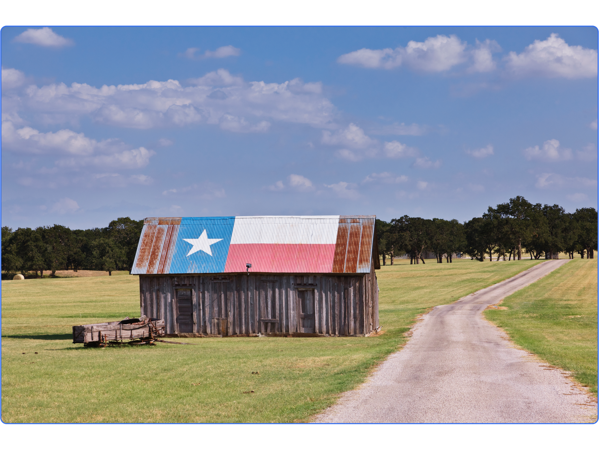 Rustic barn with Texas flag painted on roof.