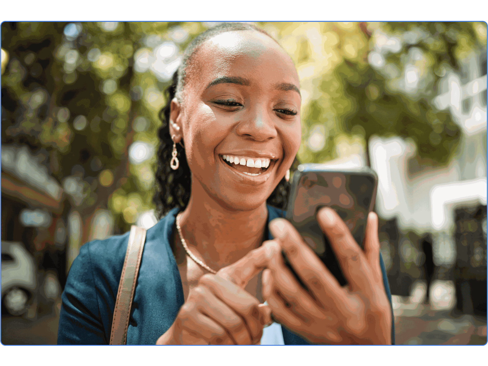 Black woman smiling and scrolling through her phone