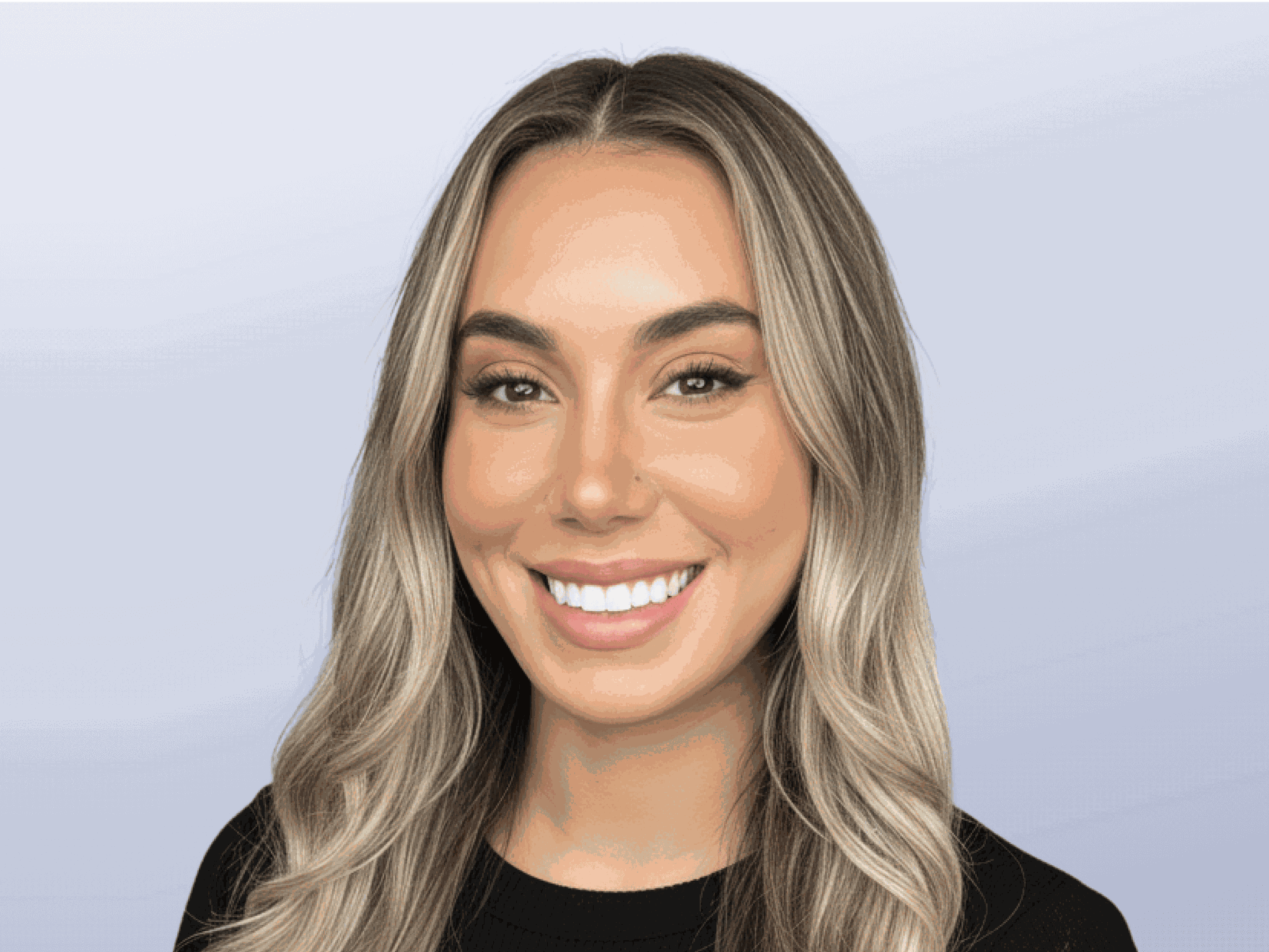 A headshot of Monterey Thompson. A woman with long wavy hair, wearing a black shirt.