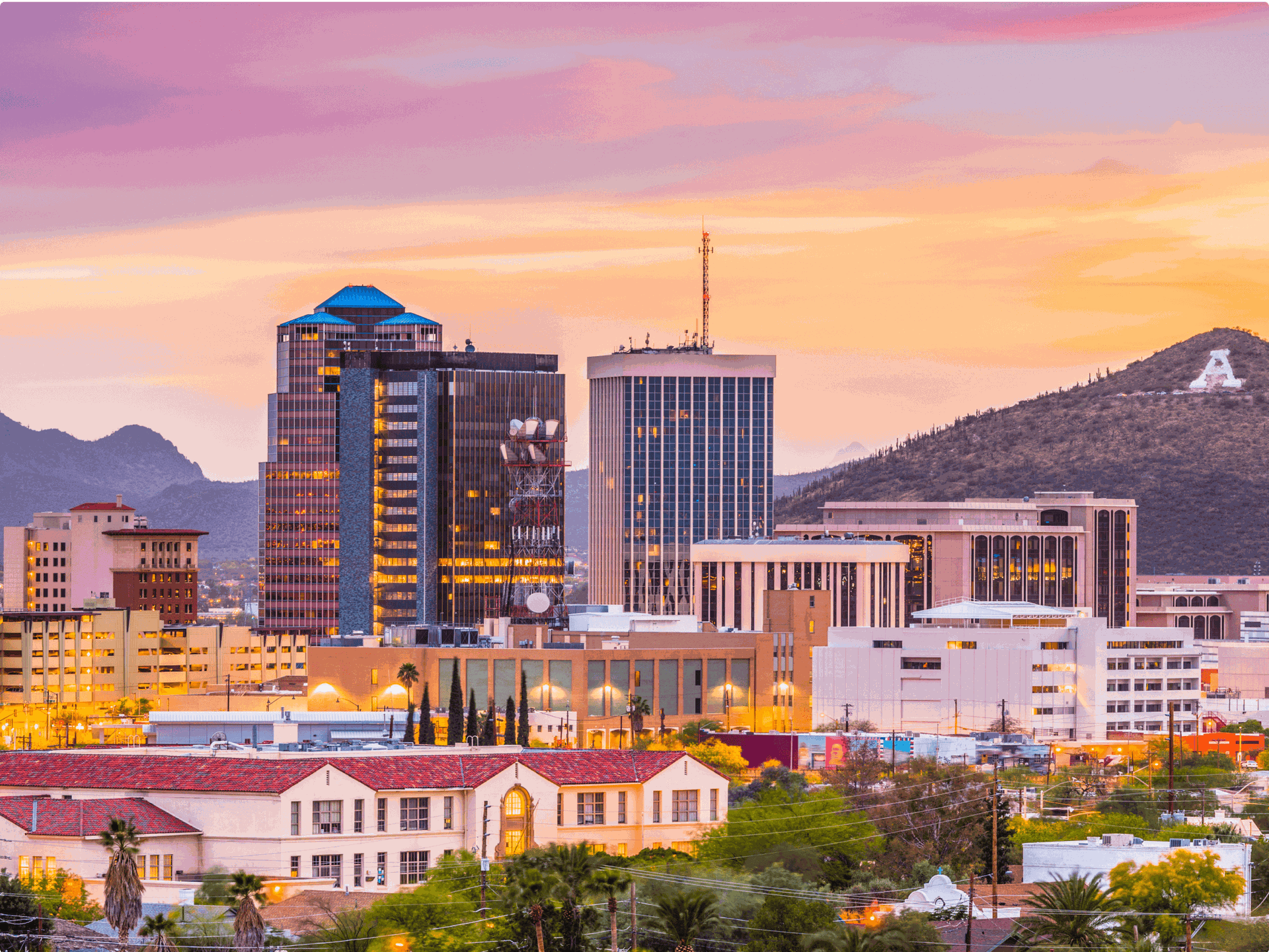 Tucson, Arizona skyline at sunset with A mountain in the distance.