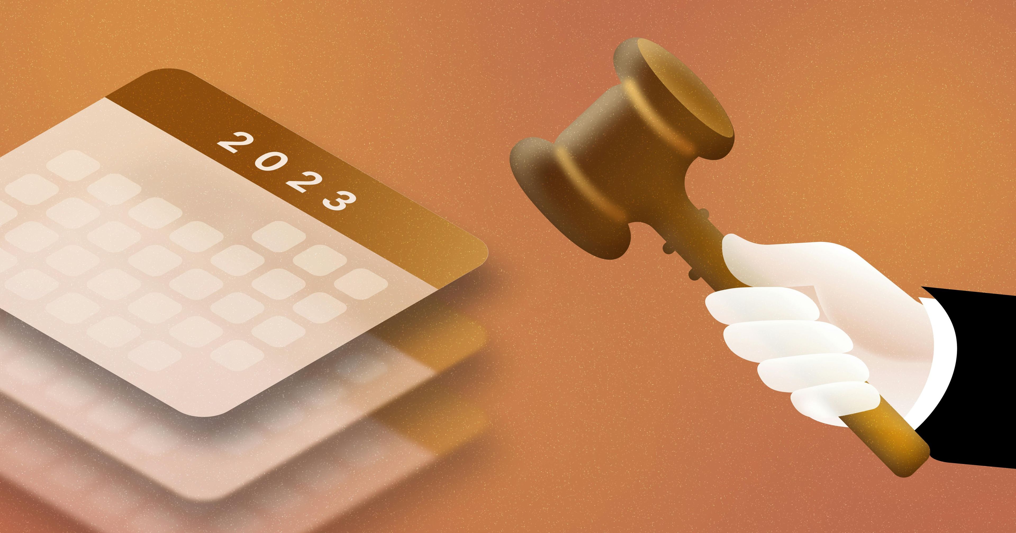 2023 calendar with a hand holding a gavel on the right side.