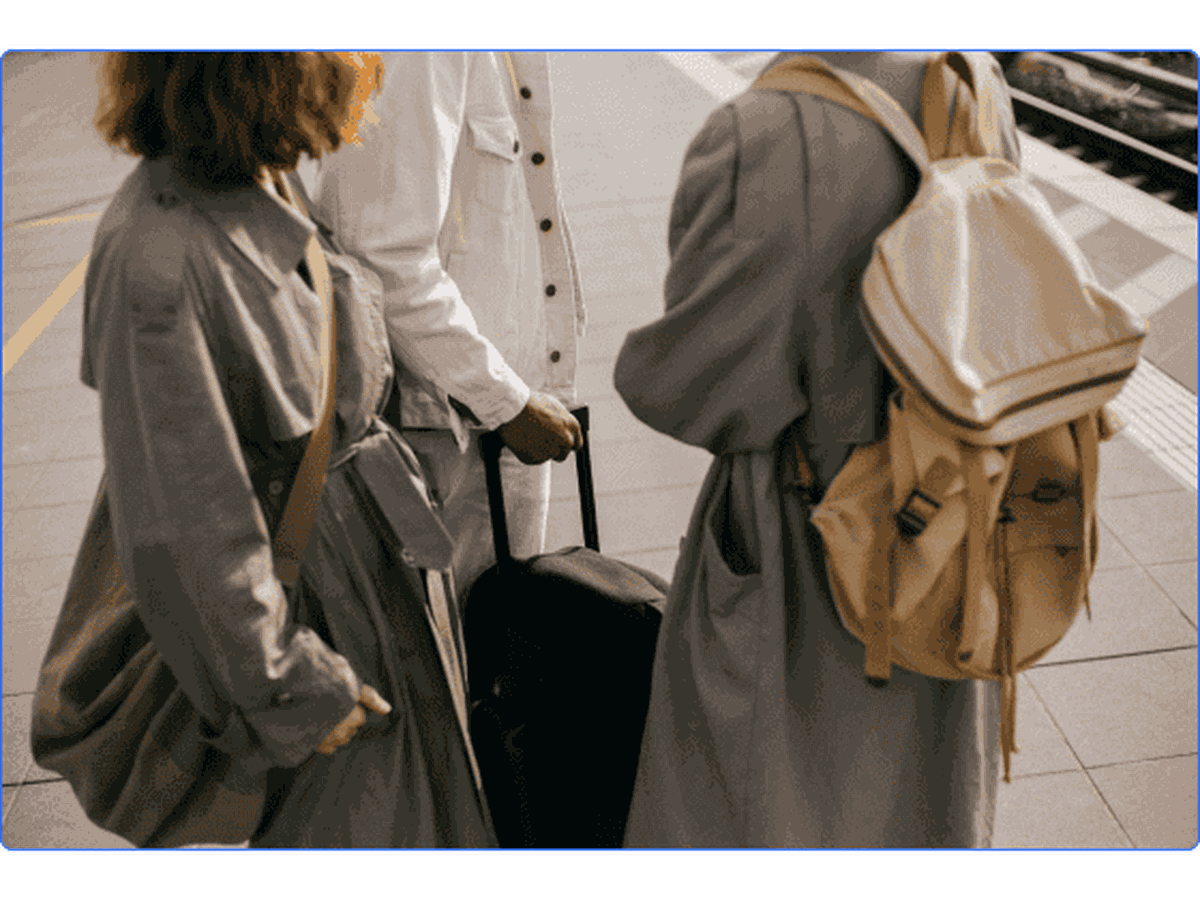 A group of people traveling with suitcases and backpacks.