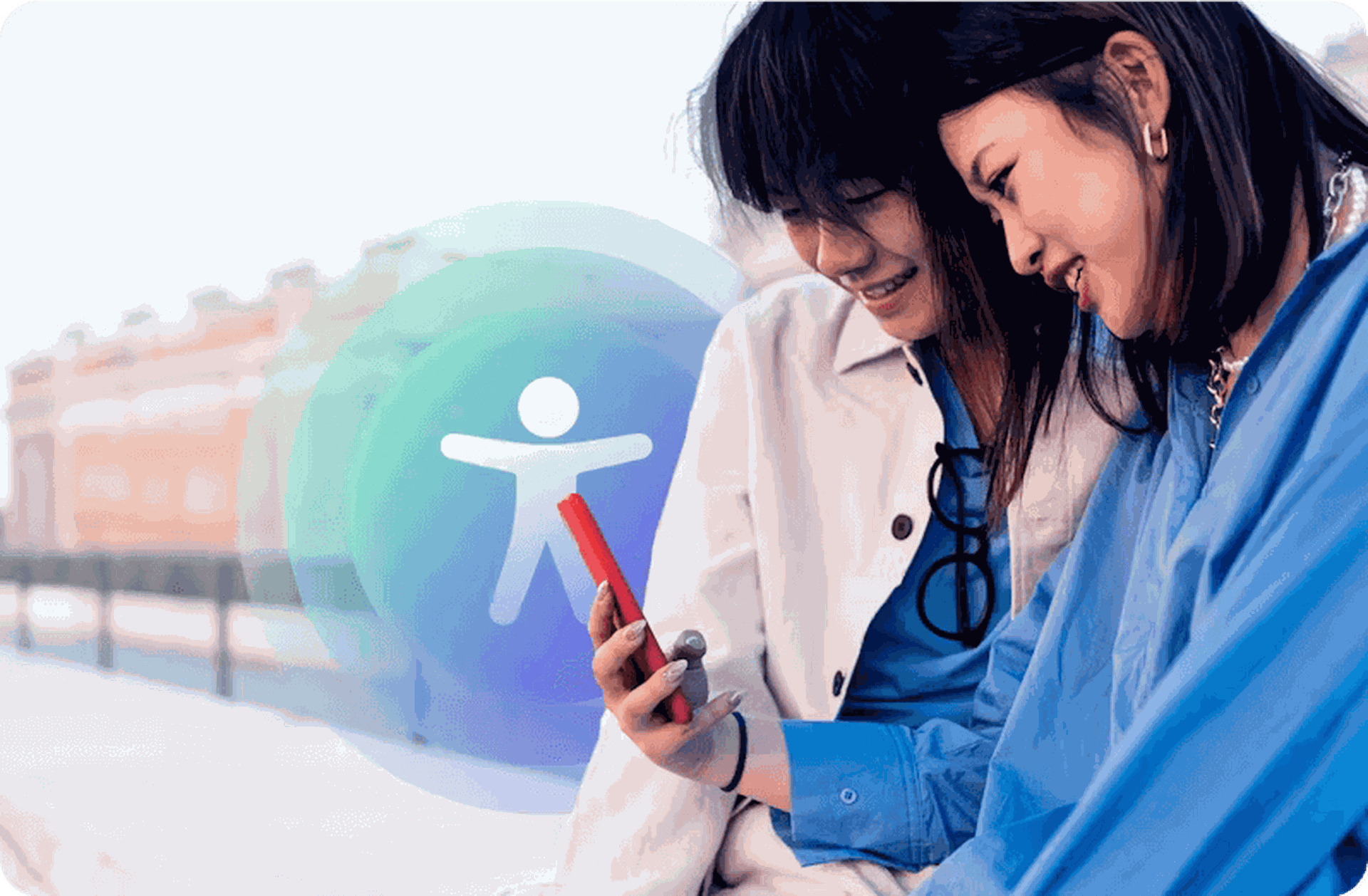 A young man and woman smile at something on the woman’s phone, in front of an accessibility symbol with a blue and green gradient background.