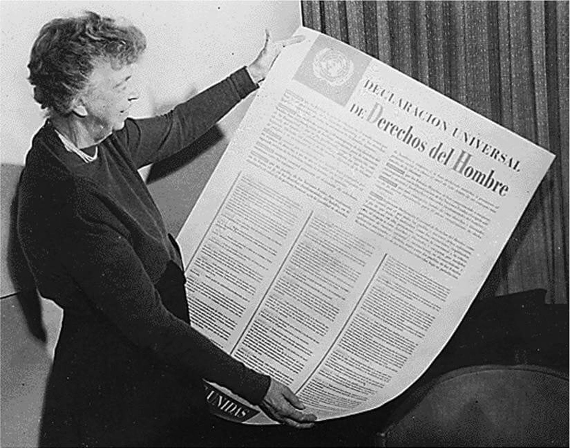 Eleanor Roosevelt is pictured holding the Universal Declaration of Human Rights, a highly influential document that she helped create.